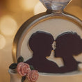 Load image into Gallery viewer, Decorative item with a silhouette of a couple and flowers on a blurred background