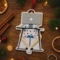 Load image into Gallery viewer, Decorative ornament of a person with a laptop on a wooden surface with Christmas decorations.