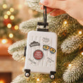 Load image into Gallery viewer, Decorative suitcase ornament with travel-themed stickers on a Christmas tree.