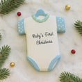 Load image into Gallery viewer, Personalized Baby’s First Christmas Ornament designed as a sweet baby bodysuit with soft blue polka dot sleeves and trim. This ornament features a raised 3D front with textured details and dimensional edges for a charming keepsake look. The baby’s name is added at the top and the year below, creating a meaningful newborn memory gift. Perfect for baby boy first Christmas, newborn celebration, holiday tree decor, and special family milestone ornament.