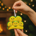 Load image into Gallery viewer, Hand holding a decorative ornament shaped like a family of tacos with faces, set against a festive background.