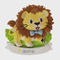 Load image into Gallery viewer, Lion themed Christmas ornament designed with a playful and colorful style, perfect for kids and animal lovers. This ornament features a lion character standing on a grassy base with a glossy finish and cheerful details. The design includes a personalization option, allowing a custom name and year to be added, making it a meaningful keepsake for children or family holiday traditions. Ideal for Christmas trees, nursery decor, or as a unique personalized gift for animal themed celebrations.