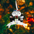 Load image into Gallery viewer, Personalized police car Christmas ornament featuring a black and white cop car design with BUSTED text, police lights and festive wreath detail. Customized with a name and year on the front banner. Glossy resin finish with bold black and white colors creates a fun and playful holiday look. Mostly 2D ornament with raised 3D details on the front only, lightweight and perfect for Christmas tree decor and police themed gifts.