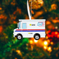 Load image into Gallery viewer, Decorative ornament shaped like a mail truck on a blurred Christmas tree background