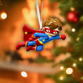 Load image into Gallery viewer, Superhero Christmas ornament with customizable name and age on a blurred Christmas tree background.