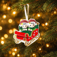 Load image into Gallery viewer, Personalized couple ornament featuring two characters sitting together in a festive sleigh design. This romantic Christmas ornament can be customized with two names and a year or family name, making it perfect for couples, partners, spouses, fiancés, or loved ones. Ideal for celebrating love, togetherness, Valentine’s Day, anniversaries, or first holidays together. A meaningful keepsake for couples who want to turn shared moments into lasting holiday memories.