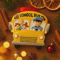Load image into Gallery viewer, Decorative school bus ornament on a wooden surface with Christmas decorations.