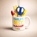 Load image into Gallery viewer, Personalized teacher ornament designed as a white mug filled with classroom tools including scissors ruler pencil and marker. The front reads Worlds Best Teacher with custom name personalization. Mostly 2D design with raised 3D tool details. A perfect Christmas ornament gift for teachers educators and school staff.