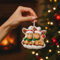 Load image into Gallery viewer, Close up view of a personalized reindeer couple ornament featuring two festive reindeer wearing Santa hats with customizable names. Designed to celebrate couples, families, siblings, or loved ones, this ornament highlights togetherness and holiday warmth. A charming Christmas keepsake perfect for tree decor, gift giving, and preserving shared holiday memories.