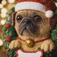 Load image into Gallery viewer, Dog figurine wearing a Santa hat with a blurred festive background