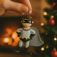 Load image into Gallery viewer, Personalized superhero boy Christmas ornament featuring a mask, cape and custom name. Cute holiday decor for boys, perfect for Christmas trees and gift-giving. Add name and year to create a unique keepsake. Display photos are AI-generated; please check the first image for the original product.