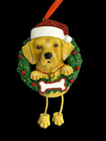 Load image into Gallery viewer, Dog Christmas ornament with a wreath, bone, and Santa hat on a black background