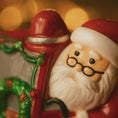 Load image into Gallery viewer, Decorative figurine of a Santa Claus with a blurred festive background