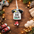 Load image into Gallery viewer, Decorative ornament shaped like a t-shirt with text, surrounded by Christmas decorations on a wooden surface.