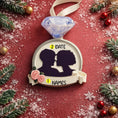 Load image into Gallery viewer, Decorative ornament with a couple's silhouette, diamond, and text on a festive background.