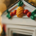 Load image into Gallery viewer, Close-up of a decorative item with a pineapple and berries on a blurred background