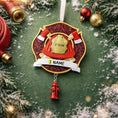 Load image into Gallery viewer, Firefighter-themed Christmas ornament with customizable text on a green background with decorations.