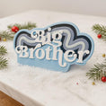 Load image into Gallery viewer, Personalized Big Brother Christmas ornament with custom name and year detail in layered blue and white design. This sibling holiday ornament features raised 3D front lettering and a lightweight flat back, perfect for Christmas tree decor.
