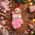 Load image into Gallery viewer, Personalized Baby Girl Christmas Ornament featuring a sweet baby in a pink stocking with raised 3D front details and textured snowflake accents. The name is added on the hat and the year on the stocking, creating a meaningful newborn keepsake. Soft pink tones, holiday elements, and dimensional design make it perfect for babyâs first Christmas, baby girl gift, and special family memory ornament for the tree.