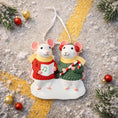 Load image into Gallery viewer, Two mouse ornaments in red and green sweaters with candy cane and music notes on a textured surface with Christmas decorations.