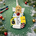 Load image into Gallery viewer, Decorative teacher angel ornament with educational items on a green background with Christmas decorations.