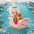 Load image into Gallery viewer, Personalized baby first Christmas ornament featuring a sweet baby sitting in a pastel pink sleigh holding a teddy bear. Handwritten baby name and year or Baby’s First Christmas text shown on the sleigh. Smooth resin finish with soft pastel tones, lightweight structure, mostly 2D ornament with raised 3D front details, designed for baby nursery themed Christmas tree decor and keepsake gifting.