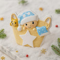 Load image into Gallery viewer, Personalized Baby First Christmas Ornament featuring a sweet newborn tucked inside a cozy woven basket with a soft blue star hat and matching blanket. This 3D front design includes raised details, textured knit pattern, and adorable teddy bear accent, creating depth and charm. Name is displayed on the hat and year on the star. A heartfelt keepsake for babyâs first holiday, nursery decor, or newborn gift. Perfect Christmas tree ornament for new parents.