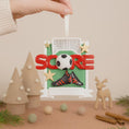 Load image into Gallery viewer, Decorative ornament with soccer ball, goal, and 'Score' text on a neutral background.