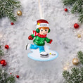 Load image into Gallery viewer, This personalized ice skating boy ornament features a cheerful winter skater wearing festive holiday clothing and gliding across an icy base. The design includes a custom name on the hat and a year displayed on the base, making it a perfect keepsake for celebrating winter memories, first Christmas moments, or a child’s love for ice skating and winter sports.