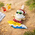 Load image into Gallery viewer, Personalized surfing Santa Christmas ornament featuring a fun beach themed Santa riding a wave on a surfboard. Raised 3D front details add depth while the back remains flat for easy hanging. Custom name and year placement make this ornament a playful and unique holiday keepsake for Christmas tree decor.
