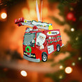 Load image into Gallery viewer, Christmas ornament of a red fire truck with Santa driving, against a blurred Christmas tree background.
