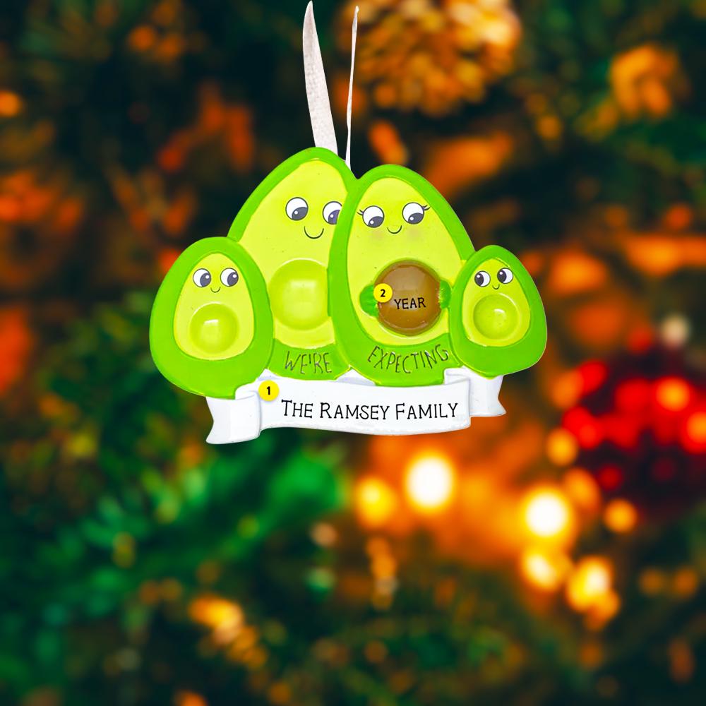 Avocado-shaped ornament with faces and text on a Christmas tree background