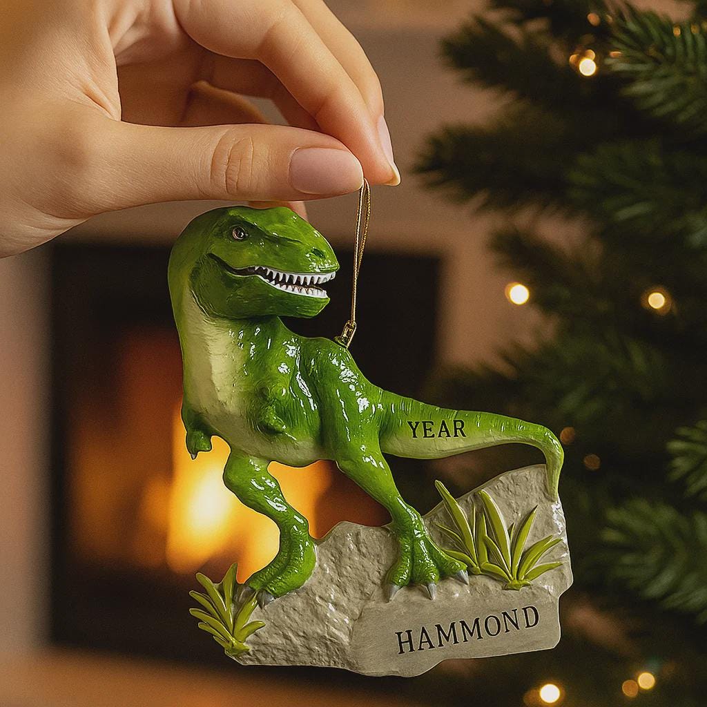 Realistic dinosaur themed Christmas ornament featuring a detailed T-Rex design with vibrant green tones and a playful yet bold appearance. Styled in a warm holiday setting, this ornament is designed to be personalized and makes a fun keepsake for kids who love dinosaurs and adventure themed decorations