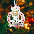 Load image into Gallery viewer, Personalized pink llama Christmas ornament featuring a cute white llama wrapped in colorful holiday lights, framed in a glittery wreath with pink accents. The top hat band can be customized with a name, while the bottom banner allows space for year or Baby’s 1st Christmas. Designed in soft pink and festive tones, this resin baby girl Christmas ornament makes a meaningful keepsake gift for celebrating a newborn’s first holiday season.

