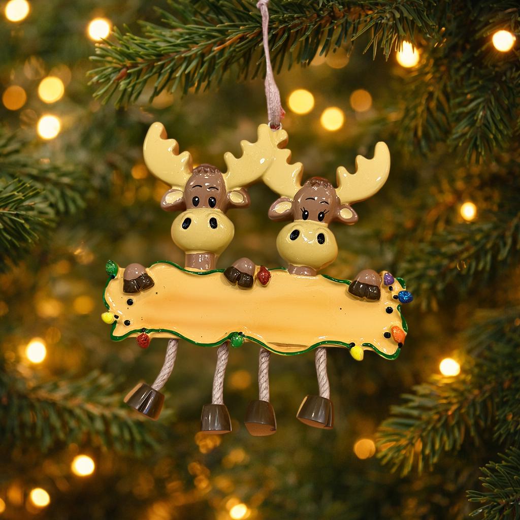 Decorative moose ornament with a banner on a Christmas tree.