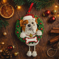 Load image into Gallery viewer, Dog Christmas ornament in a wreath with festive decorations on a wooden surface
