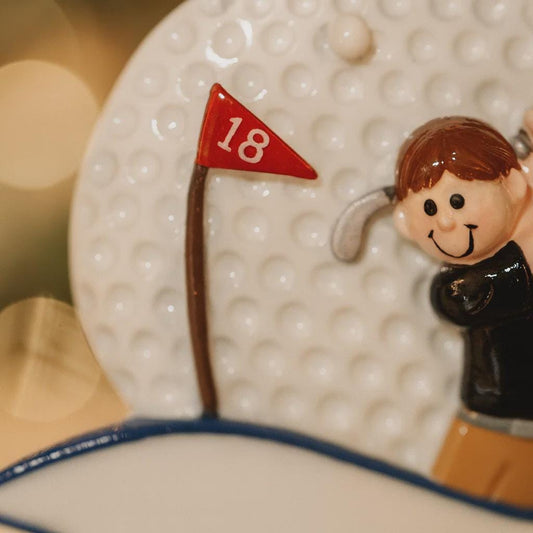 Decorative item with a golfer and number 18 flag on a textured surface