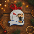 Load image into Gallery viewer, Decorative Christmas ornament with a golfer on a golf ball, surrounded by festive decorations on a wooden surface.
