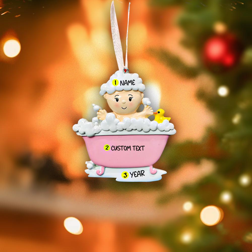 Personalized Christmas ornament of a baby in a bathtub with customizable text, against a festive background.