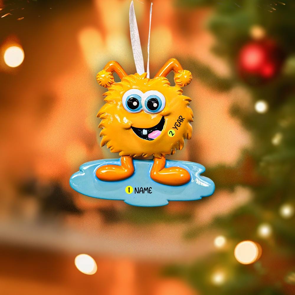 Orange cartoon character ornament with a blurred Christmas tree background