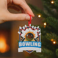 Load image into Gallery viewer, Bowling themed Christmas ornament featuring a raised 3D bowling ball striking detailed bowling pins on a shield style base. Personalized name and year placement is clearly visible on the front. Festive holiday styling with sports inspired details makes this ornament a perfect keepsake for bowling fans league players and Christmas tree decor.
