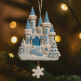 Load image into Gallery viewer, Decorative Christmas ornament of a snowy castle with blue roofs on a blurred light background.
