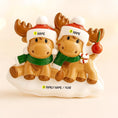 Load image into Gallery viewer, Two moose figurines wearing hats and scarves on a beige background

