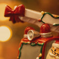 Load image into Gallery viewer, Decorative teapot with a red bow and festive design on a blurred background
