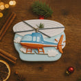 Load image into Gallery viewer, Decorative helicopter ornament on a wooden surface with cinnamon sticks and an orange peel.
