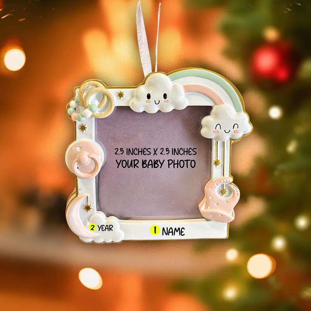 Decorative photo frame with cloud and rainbow design on a blurred Christmas tree background.