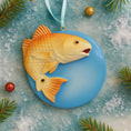 Load image into Gallery viewer, Decorative fish ornament on a blue background with Christmas elements.
