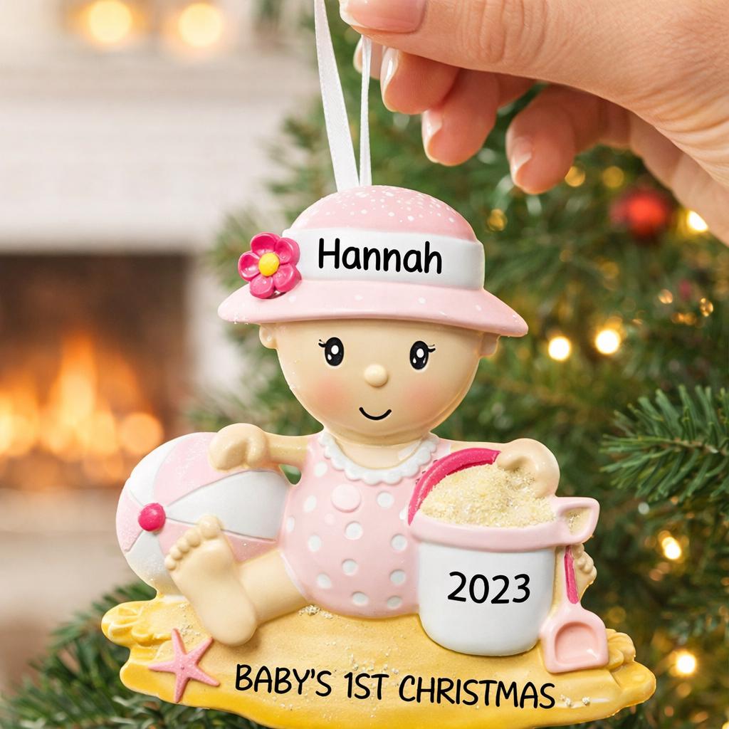 Personalized baby first Christmas ornament for baby girl featuring a beach and summer inspired design. This adorable keepsake includes handwritten name and year personalization, a soft pink baby figure, sand details and playful seaside elements. The ornament has a lightweight 2D base with raised 3D detailing on the front only. Perfect for baby’s first Christmas, nursery decor, coastal holiday themes and meaningful family gifts.