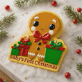 Load image into Gallery viewer, Gingerbread man ornament with 'Baby's First Christmas' text on a snowy background

