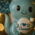 Load image into Gallery viewer, Blue axolotl figurine with 'I ❤️ U Axolotl!' text on a blurred background
